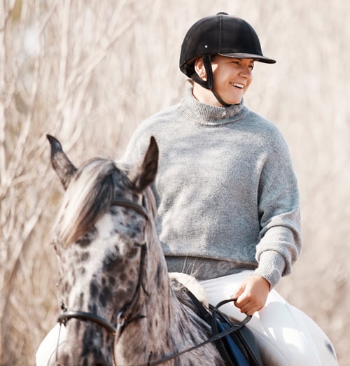 Preview: Shot of an attractive young woman riding with her horse outside