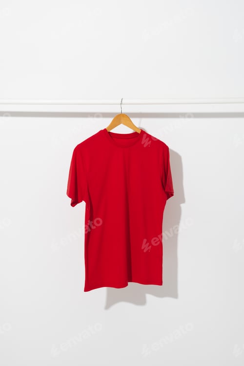 Preview: Red T-Shirt on a Hanger Against White Wall