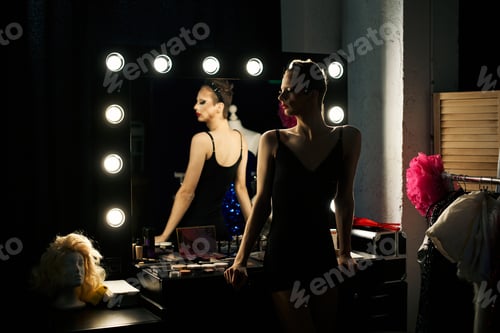 Preview: Drag queen prepares backstage in dimly lit dressing room