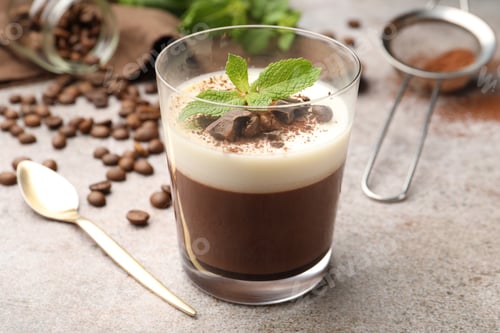 Preview: Delicious coffee panna cotta, beans and mint on grey table, closeup