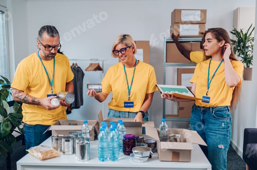 Preview: Group of multiracial volunteers working in community charity donation center
