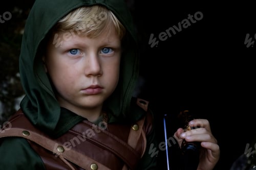 Preview: Close up portrait of a boy in a medieval costume against a forest background