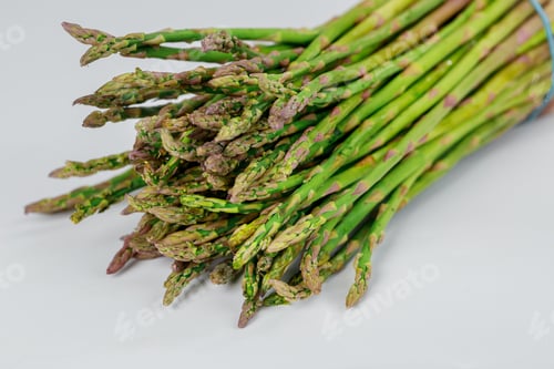 Preview: Organic fresh green asparagus on a white background.