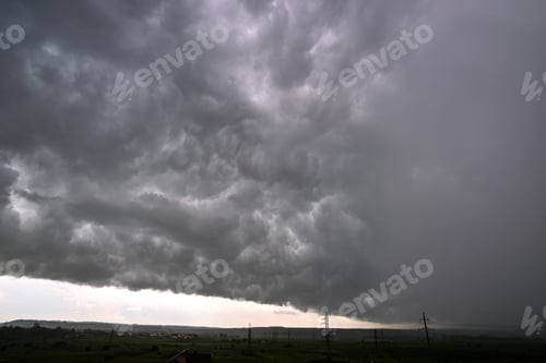 Preview: Landscape of dark ominous clouds forming on stormy sky during heavy thunderstorm