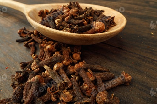 Preview: Heap of clove spice on wooden table
