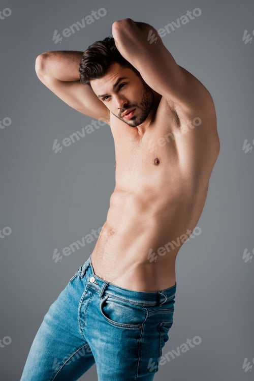 Preview: handsome sexy shirtless macho in jeans isolated on grey