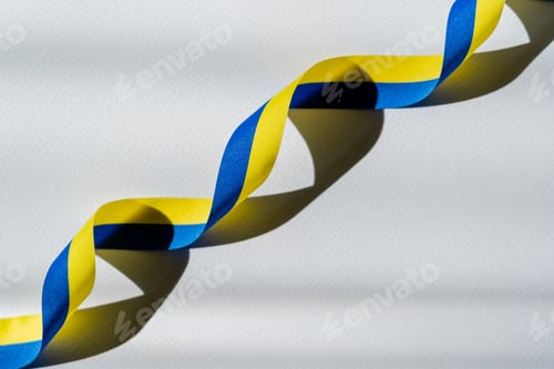 Preview: Top view of curly blue and yellow ribbon with shadow on white background