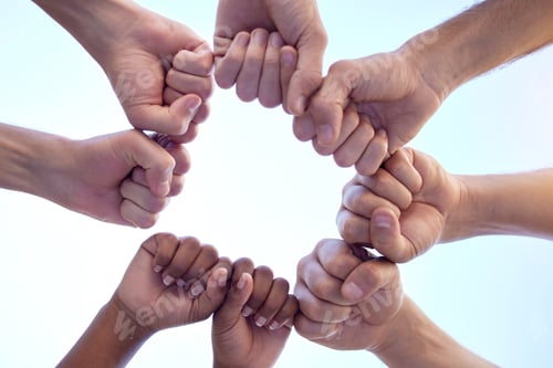 Preview: Your support is always appreciated. Shot of a group of people fist bumping one another in a circle.