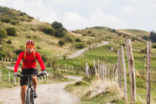 Preview: Man riding mountain bike on country road