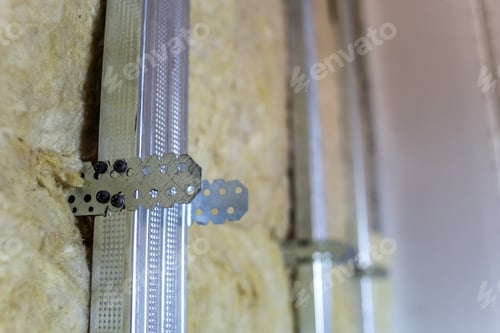 Preview: Wall of a room under renovation with mineral rock wool insulation and metal frame