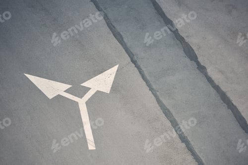 Preview: two way arrow symbol on grey asphalt road