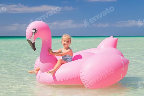 Preview: Cute little Caucasian girl enjoys summer tropical vacations on sea or ocean and smiling at hot day
