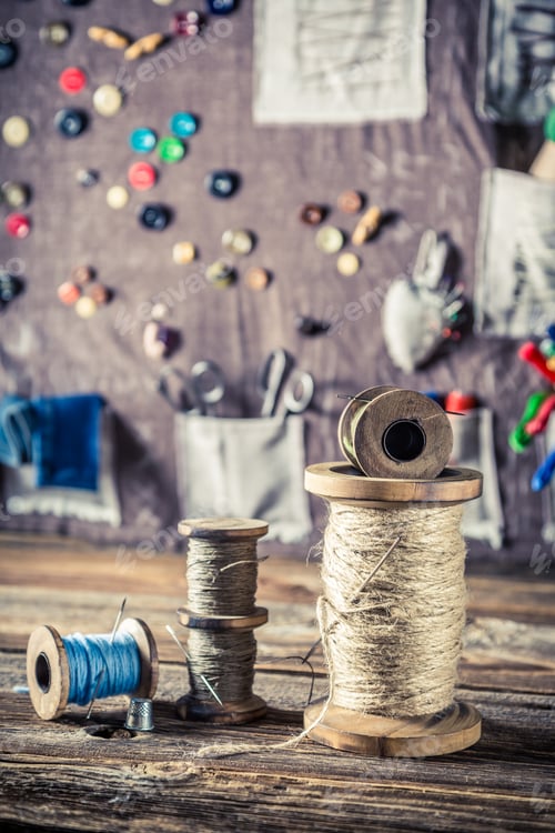 Preview: Needles and threads on buttons mat background in tailor workshop