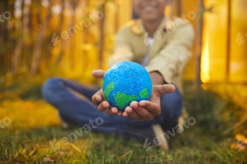 Preview: Smiling African-American Boy Holding Planet