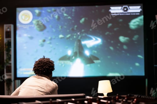 Preview: Gamer in front of gigantic smart TV watching content creator piloting spaceship in galaxy during