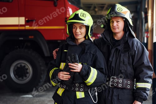 Preview: Male and female firefighters in protective uniform standing together
