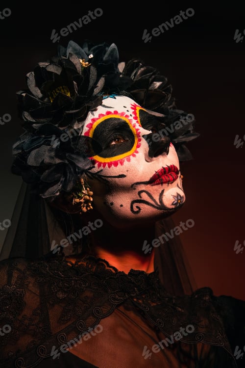 Preview: Portrait of woman in mexican day of dead costume standing on burgundy background
