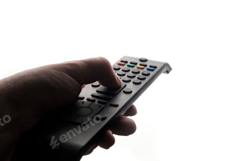 Preview: Hand holding tv remote isolated on white background.