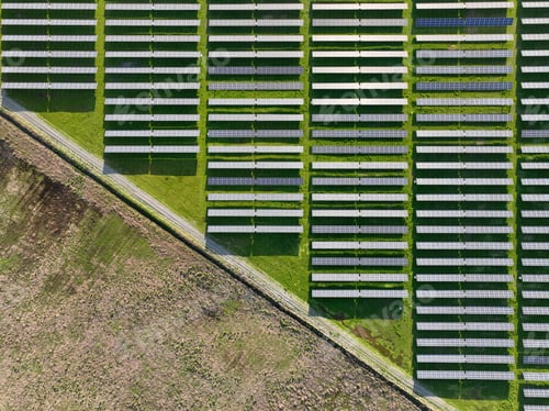 Preview: Solar panels on field in summer, aerial drone view