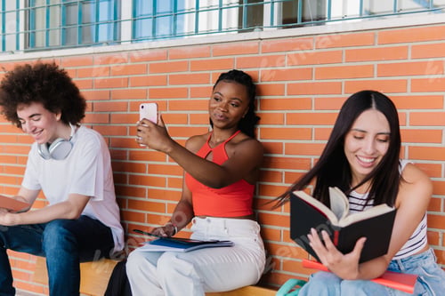 Preview: African student taking a selfie sitting next to class mates