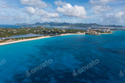 Preview: a view of a beautiful island in the ocean with a beach and mountains