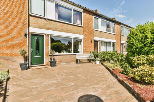 Preview: The facade of a brick building with wooden door