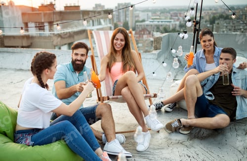 Preview: Friends having party on top of the roof. Fun, summer, city lifestyle and friendship concept