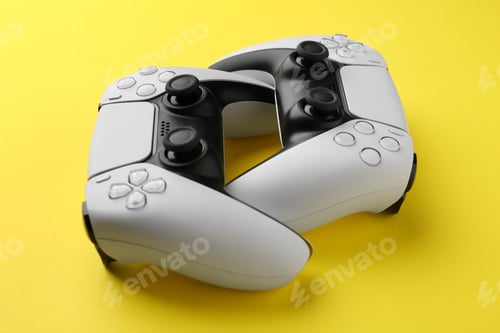 Preview: Two wireless game controllers on yellow background