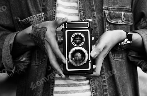 Person Holding a Classic Camera in Black and White