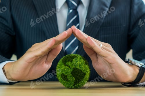 Preview: World environment day.Hand of businessman protect green world, Save world concept.