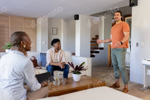 Preview: Friends enjoying conversation in modern living room, smiling and engaging warmly