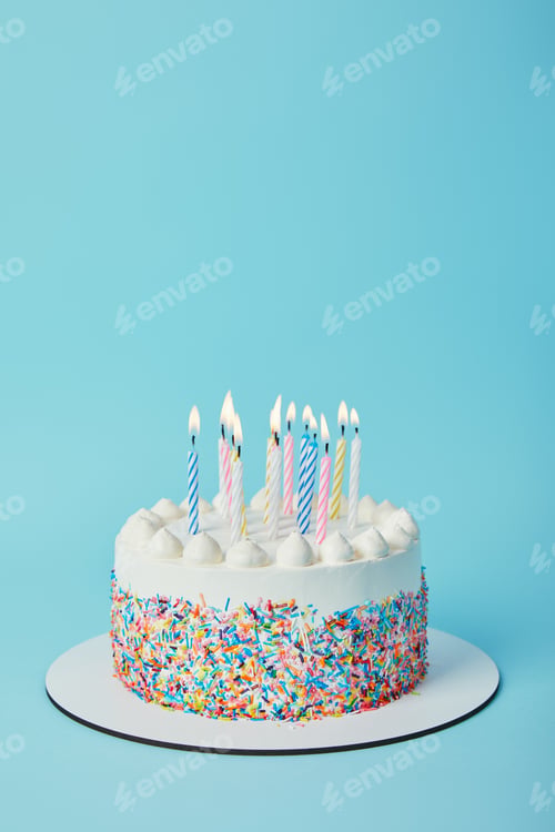 Preview: Tasty birthday cake with lighting candles on blue background
