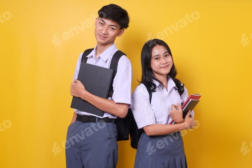 Preview: Confident Students Standing Back to Back Holding Books