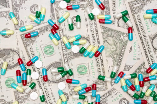 Preview: Pharmaceutical and health concept, Variety of antibiotic capsules and pills on dollar background