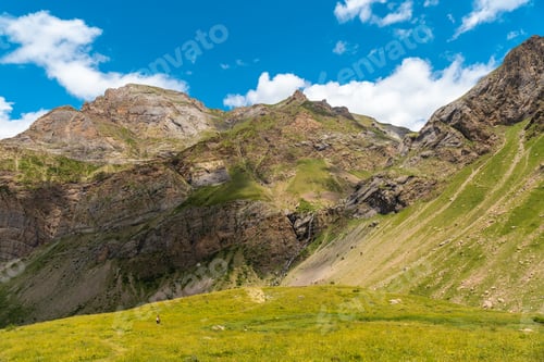Preview: A young female hiker walking towards Salto de Tendendera waterfall in Ripera Valley, Huesca