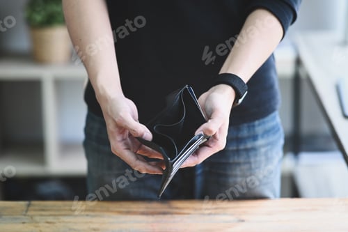Preview: Man holding empty wallet. Bankruptcy, unemployment and financial crisis concept.