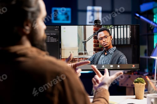 Preview: Programmer checking code with colleague in online teleconference