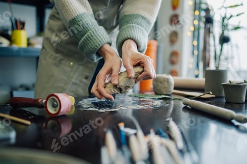 Preview: Ceramist kneading clay in pottery workshop
