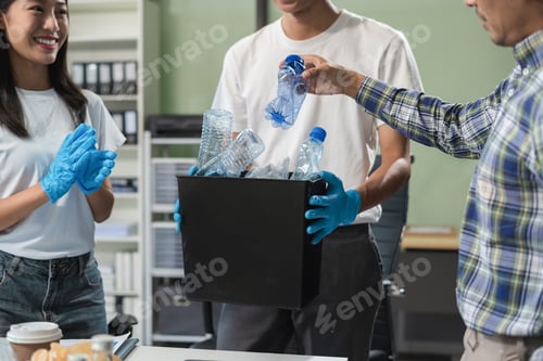 Preview: Business people working examining waste recyclable separation divided bin in the office