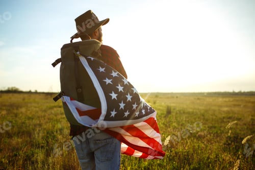 Preview: Traveler with the flag of America. The man in a hat, a backpack