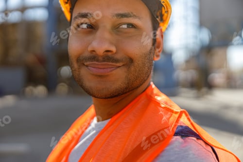 Preview: Photo of happy male multiethnic worker in plant