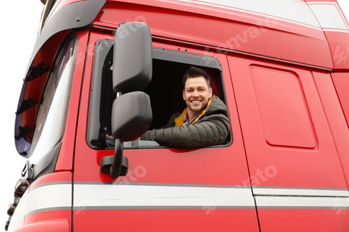 Preview: Portrait of happy driver in cab of modern truck