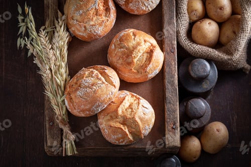 Preview: Tasty and fresh potato buns in rustic cellar.
