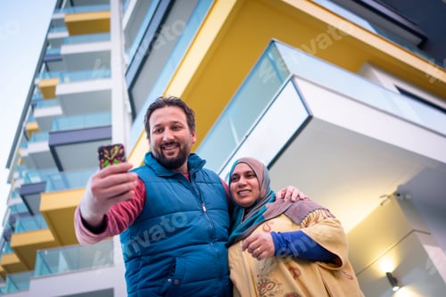 Preview: Muslim couple taking selfie on city street