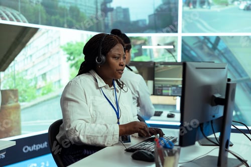 Preview: African american employee uses surveillance footage to monitor traffic