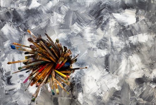 Preview: pantbrush or brushes in basket holder at painted background texture
