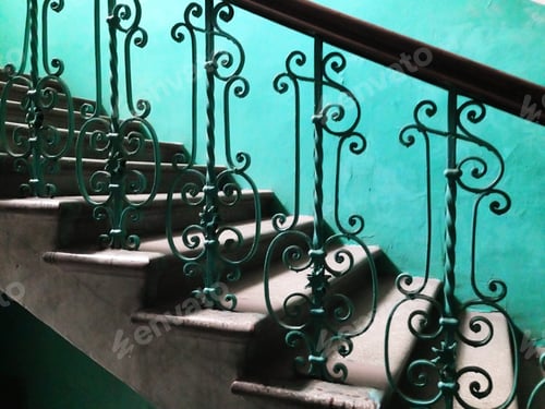 Preview: Ornate Green Railing on Staircase with Blue Wall