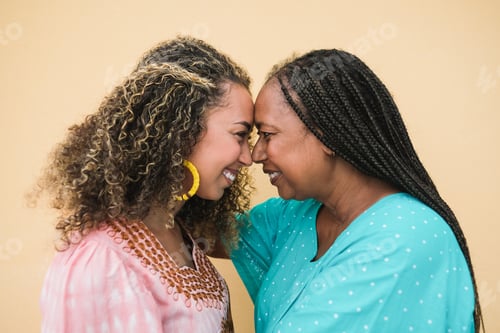Preview: Happy african mother and adult daughter having tender moment together