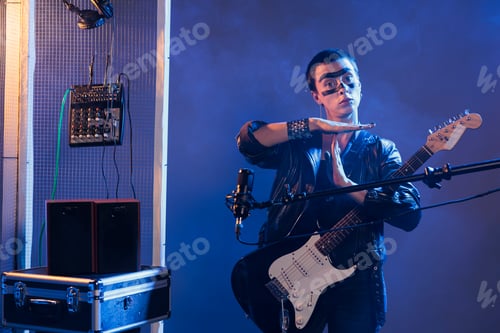 Preview: Punk artist doing t shape symbol in studio