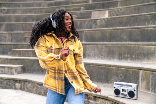Preview: Black woman listening to music and dancing